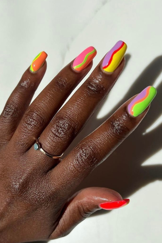 neon pink orange yellow green nails with a swirly line